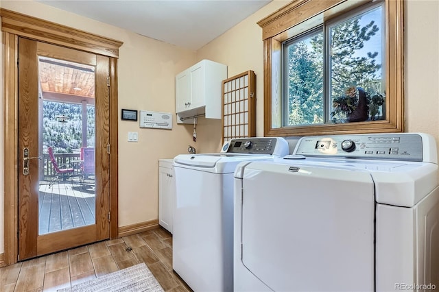 9659 S Turkey Creek Rd, Morrison, CO 80465 - washroom with separate washer and dryer, cabinet space, wood tiled floors, and baseboards