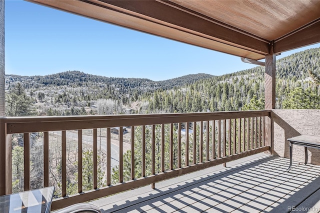 9659 S Turkey Creek Rd, Morrison, CO 80465 - wooden terrace with a mountain view and a view of trees