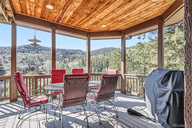 9659 S Turkey Creek Rd, Morrison, CO 80465 - wooden terrace with outdoor dining space, a mountain view, a forest view, and grilling area