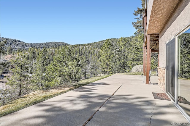 9659 S Turkey Creek Rd, Morrison, CO 80465 - view of patio featuring a view of trees