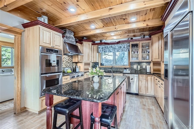 9659 S Turkey Creek Rd, Morrison, CO 80465 - kitchen with appliances with stainless steel finishes, washer / clothes dryer, wooden ceiling with exposed beams, decorative backsplash, and plenty of natural light