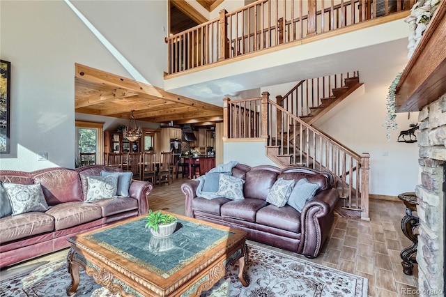 9659 S Turkey Creek Rd, Morrison, CO 80465 - living room with beamed ceiling, a high ceiling, stairs, wood finished floors, and baseboards