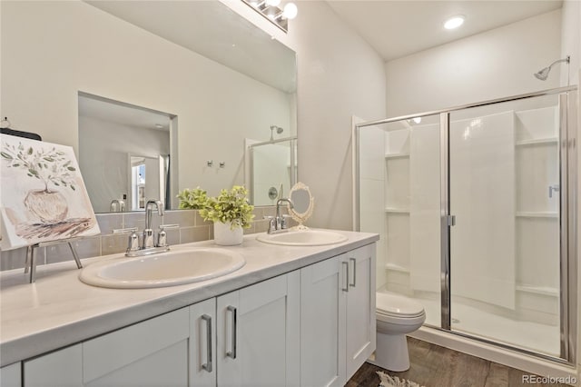 254 Gila Trl, Ault, CO 80610 - full bath with a shower stall, wood finished floors, toilet, and double vanity