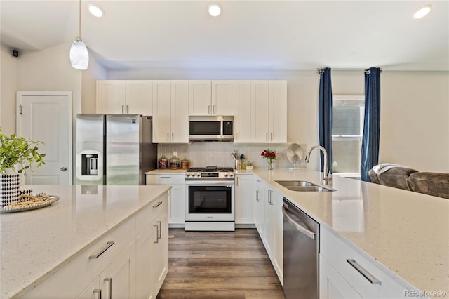 254 Gila Trl, Ault, CO 80610 - kitchen featuring appliances with stainless steel finishes, a sink, light stone countertops, recessed lighting, and tasteful backsplash