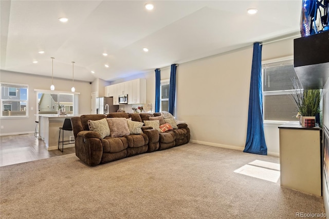 254 Gila Trl, Ault, CO 80610 - living area with light colored carpet, baseboards, vaulted ceiling, and recessed lighting