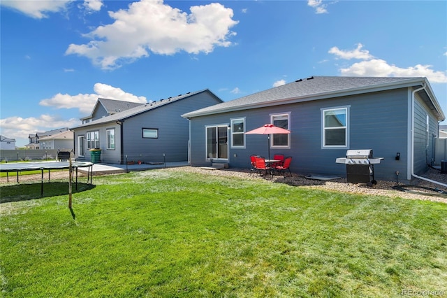 254 Gila Trl, Ault, CO 80610 - rear view of property featuring a trampoline, a patio area, and a yard