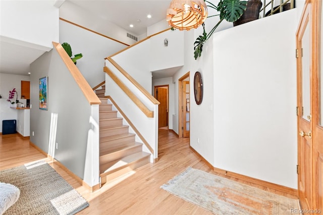 597 Pine Glade Rd, Nederland, CO 80466 - entryway featuring a towering ceiling, stairway, wood finished floors, and recessed lighting