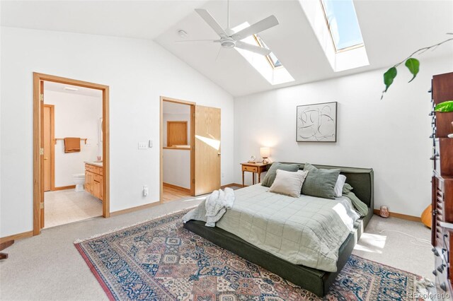 597 Pine Glade Rd, Nederland, CO 80466 - bedroom with lofted ceiling, a skylight, baseboards, light carpet, and ensuite bath