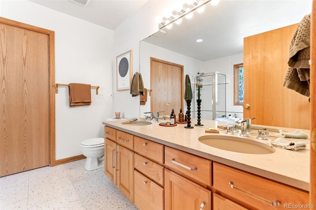 597 Pine Glade Rd, Nederland, CO 80466 - bathroom with a stall shower, double vanity, toilet, and baseboards