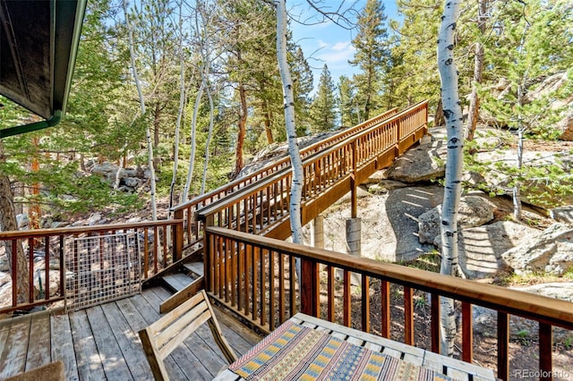 597 Pine Glade Rd, Nederland, CO 80466 - wooden terrace with stairway and view of scattered trees