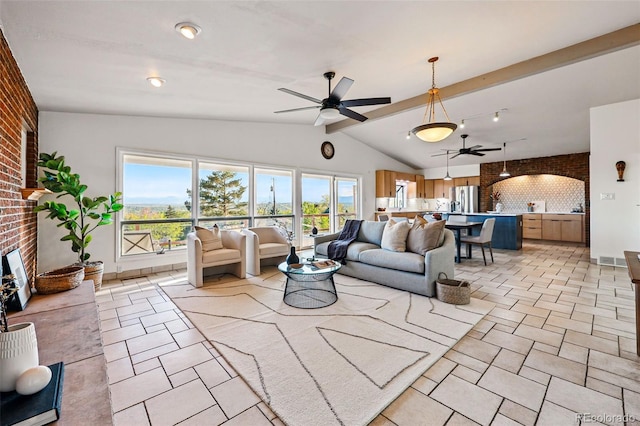 8090 Newton St, Westminster, CO 80031 - living room with a ceiling fan, vaulted ceiling, a large fireplace, brick wall, and light tile patterned floors