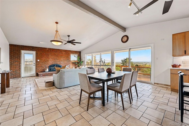 8090 Newton St, Westminster, CO 80031 - dining area featuring a ceiling fan, brick wall, and a brick fireplace