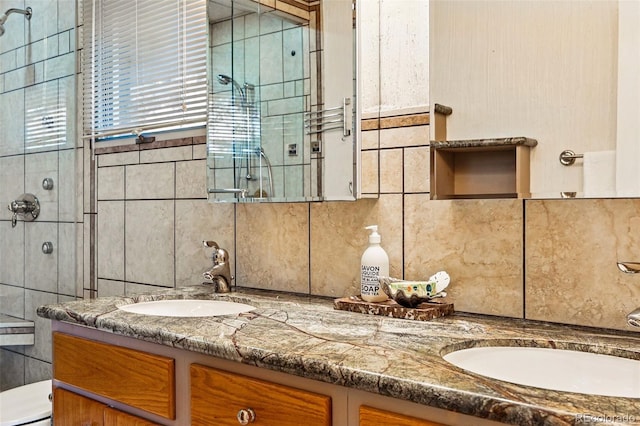 8090 Newton St, Westminster, CO 80031 - full bathroom with a shower stall, tile walls, double vanity, decorative backsplash, and toilet