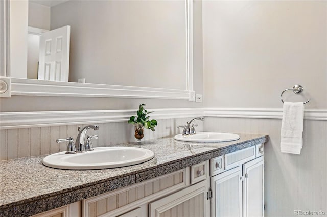 8090 Newton St, Westminster, CO 80031 - bathroom featuring wainscoting and double vanity