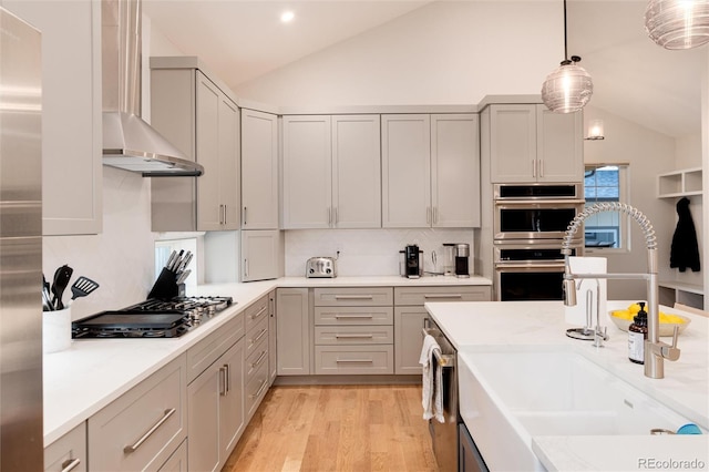 4711 S Logan St, Englewood, CO 80113 - kitchen featuring wall chimney exhaust hood, lofted ceiling, appliances with stainless steel finishes, a sink, and tasteful backsplash