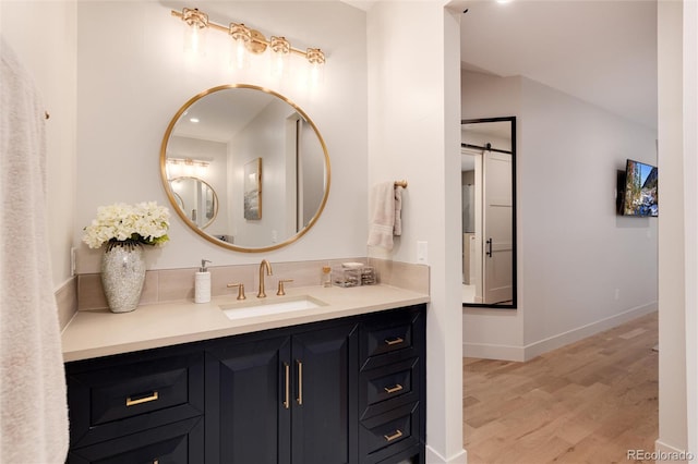 4711 S Logan St, Englewood, CO 80113 - bathroom with wood finished floors, vanity, and baseboards