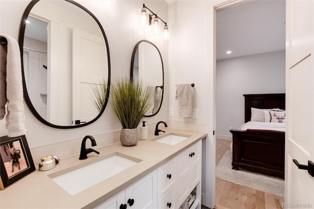 4711 S Logan St, Englewood, CO 80113 - full bath featuring double vanity, wood finished floors, and recessed lighting