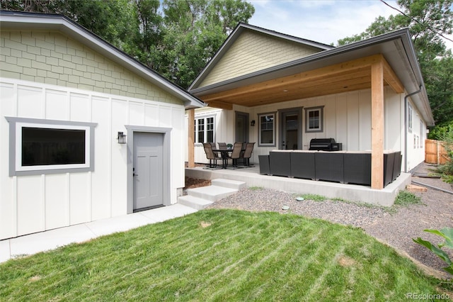 4711 S Logan St, Englewood, CO 80113 - back of house featuring board and batten siding, an outdoor hangout area, and a yard