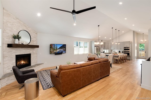 4711 S Logan St, Englewood, CO 80113 - living area featuring high vaulted ceiling, a fireplace, plenty of natural light, light wood-style floors, and recessed lighting