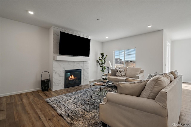 18001 Herrera Dr, Parker, CO 80134 - living area with wood finished floors, a tile fireplace, baseboards, and recessed lighting
