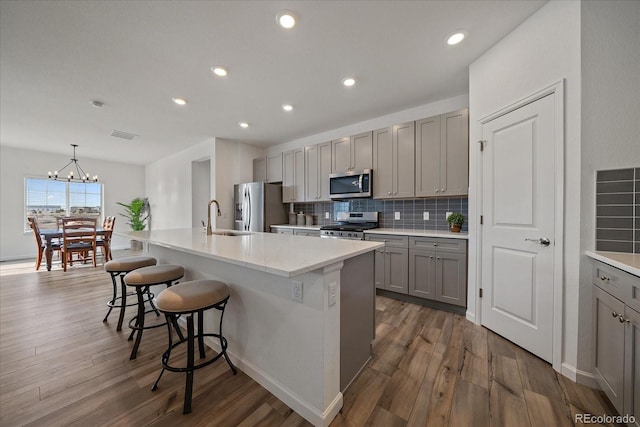 18001 Herrera Dr, Parker, CO 80134 - kitchen with appliances with stainless steel finishes, gray cabinetry, a sink, dark wood-style floors, and recessed lighting