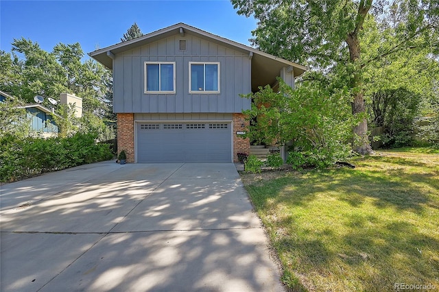 view of front of home with a front yard and a garage