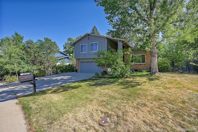 view of front of home featuring a garage and a front yard