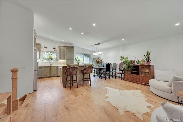 interior space featuring light hardwood / wood-style flooring, lofted ceiling, and sink