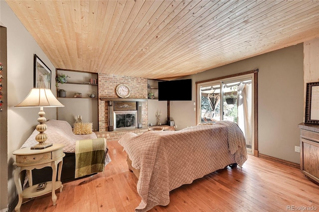 living room featuring a fireplace, light hardwood / wood-style floors, and wooden ceiling