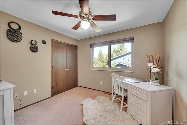 office space with ceiling fan and light colored carpet