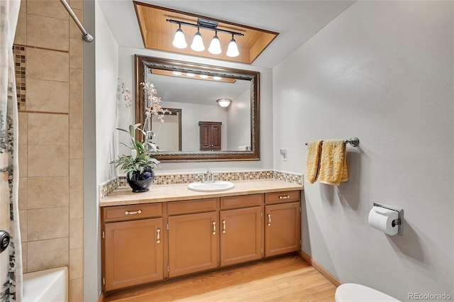 full bathroom with shower / bath combo, vanity, toilet, and hardwood / wood-style flooring