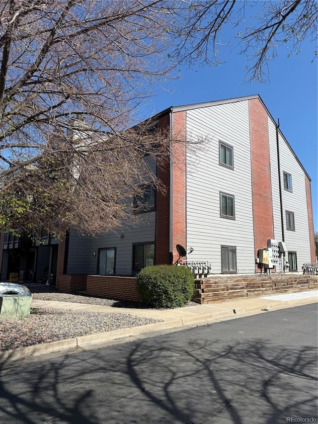 view of home's exterior with brick siding