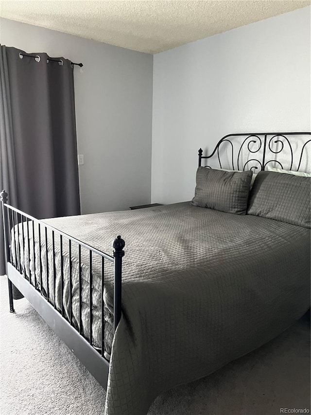 carpeted bedroom with a textured ceiling
