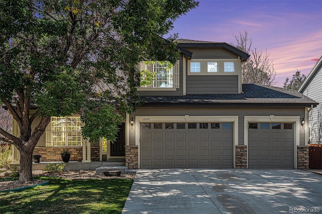 view of front of home featuring stone siding, driveway, and roof with shingles