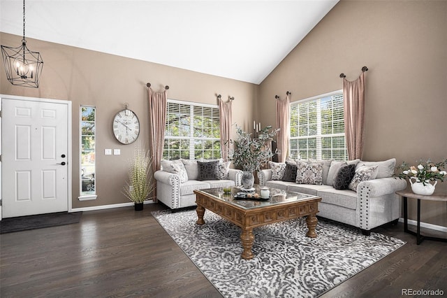 living area featuring a chandelier, baseboards, high vaulted ceiling, and dark wood-style floors