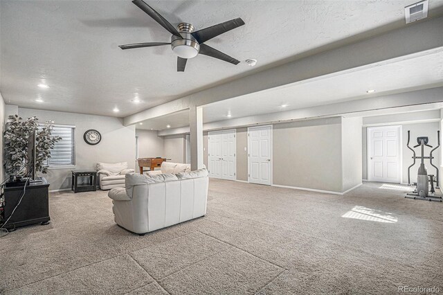 living room featuring light carpet, visible vents, and a textured ceiling