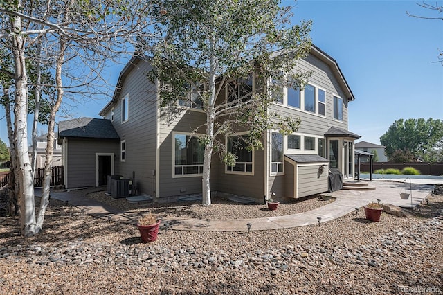 rear view of property featuring central AC