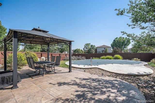 view of patio featuring outdoor dining space, a gazebo, and a fenced backyard