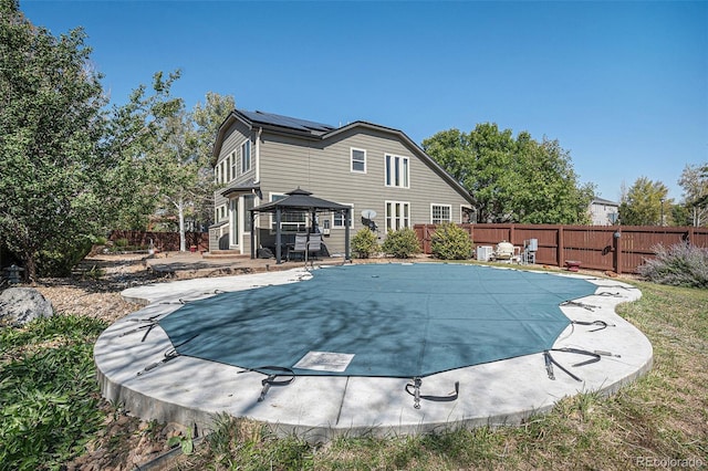 view of swimming pool featuring a gazebo, a fenced in pool, a patio, and a fenced backyard