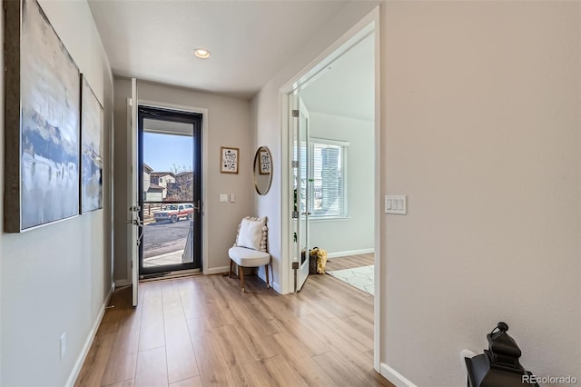 entryway featuring light wood-style flooring, recessed lighting, and baseboards