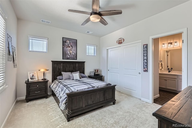 bedroom featuring baseboards, visible vents, and light carpet