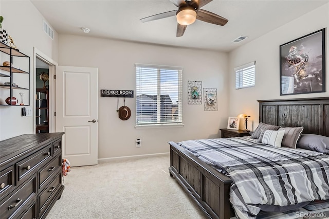 bedroom with ceiling fan, light colored carpet, visible vents, and baseboards