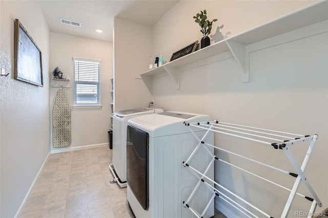 laundry room with visible vents, washer and dryer, recessed lighting, baseboards, and laundry area