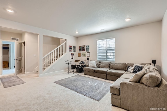 living area with light carpet, visible vents, recessed lighting, and stairs