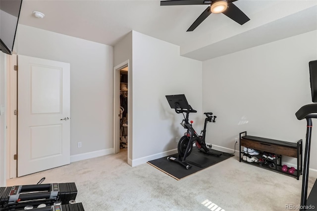 exercise area with baseboards, ceiling fan, and carpet floors