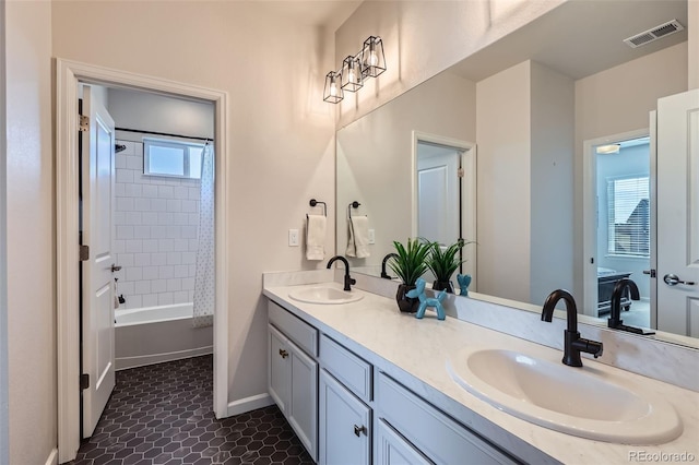 full bath with a sink, visible vents, shower / bath combo with shower curtain, and double vanity