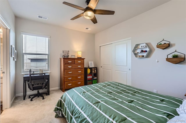 bedroom with visible vents, light colored carpet, a ceiling fan, and baseboards