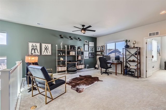 office space with carpet, visible vents, and baseboards