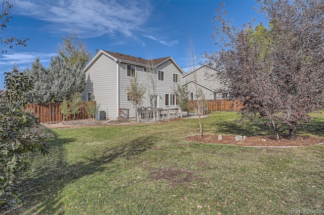 back of property with a patio, central AC, and a lawn