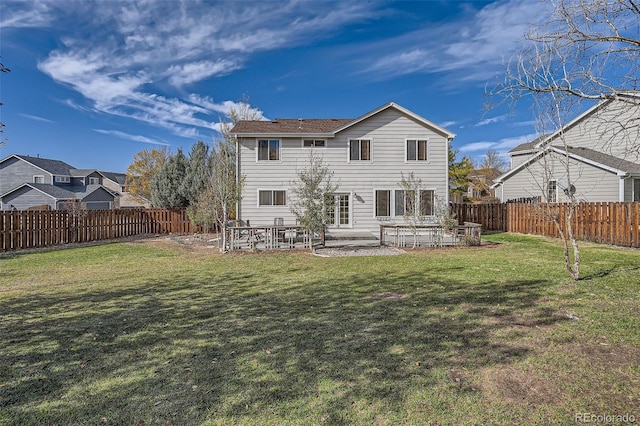 rear view of house with a patio and a yard